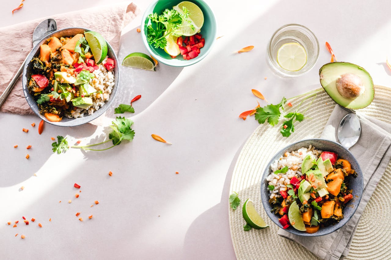 about-us-01 Top-down view of vibrant vegan bowls filled with fresh vegetables, perfect for a healthy meal.