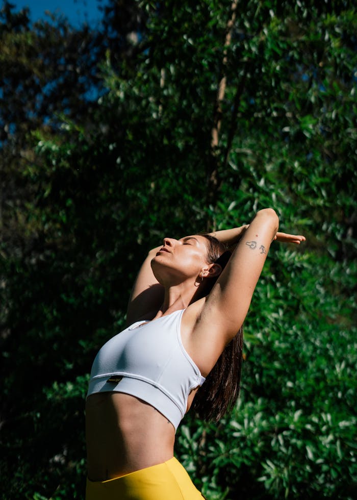 services-01 A woman in a yoga pose outdoors, symbolizing a healthy lifestyle and mindfulness.