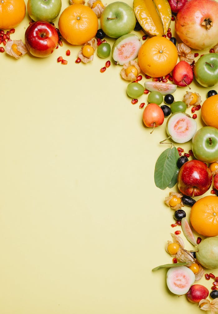 services-03 Fresh and colorful assortment of tropical and exotic fruits arranged on a bright yellow background.